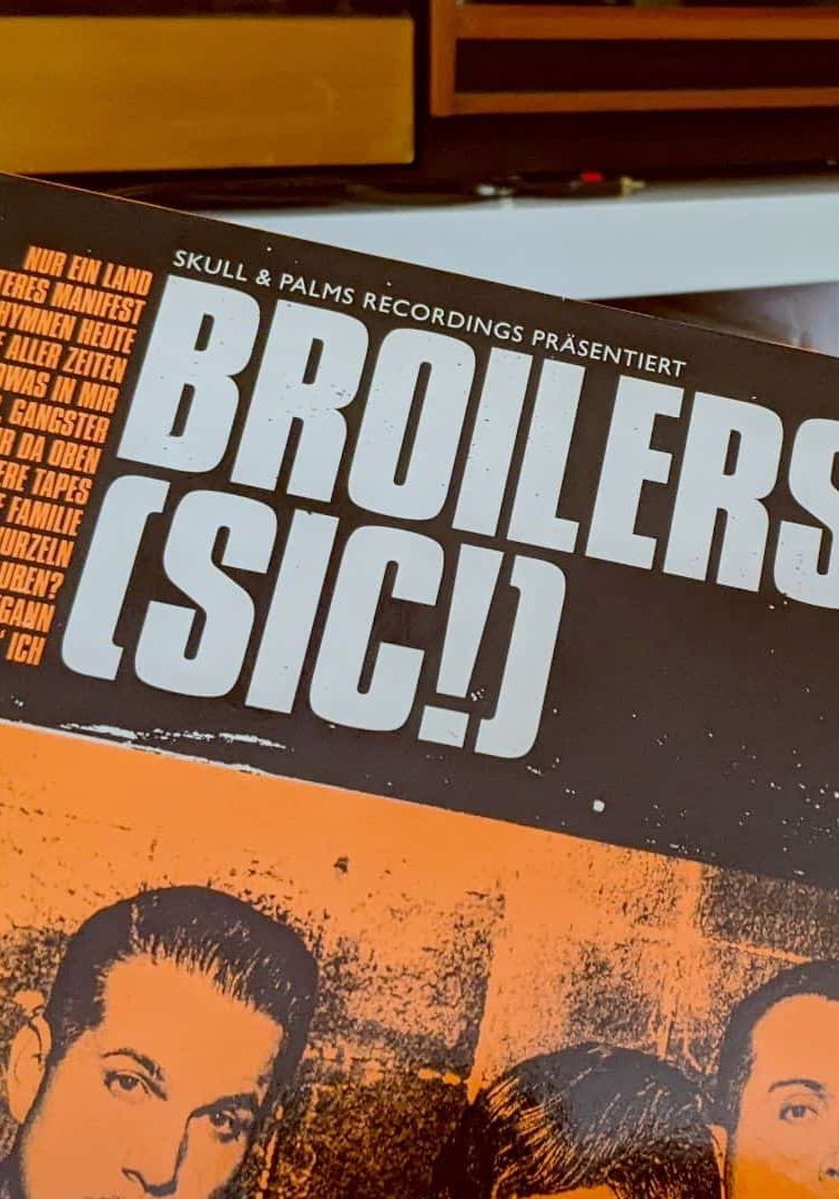 Record called SIC by German band Broilers taken from the vinyl collection showing behind it. Ready play this record.